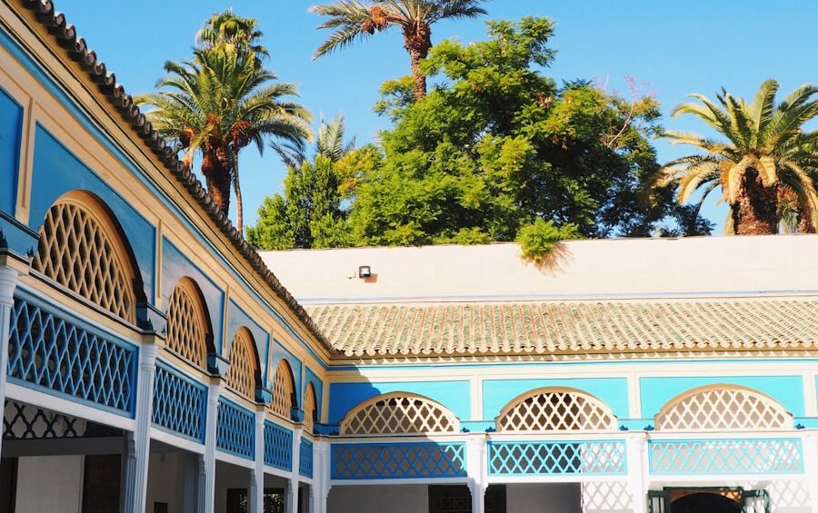the courtyard of a building with palm trees in the background